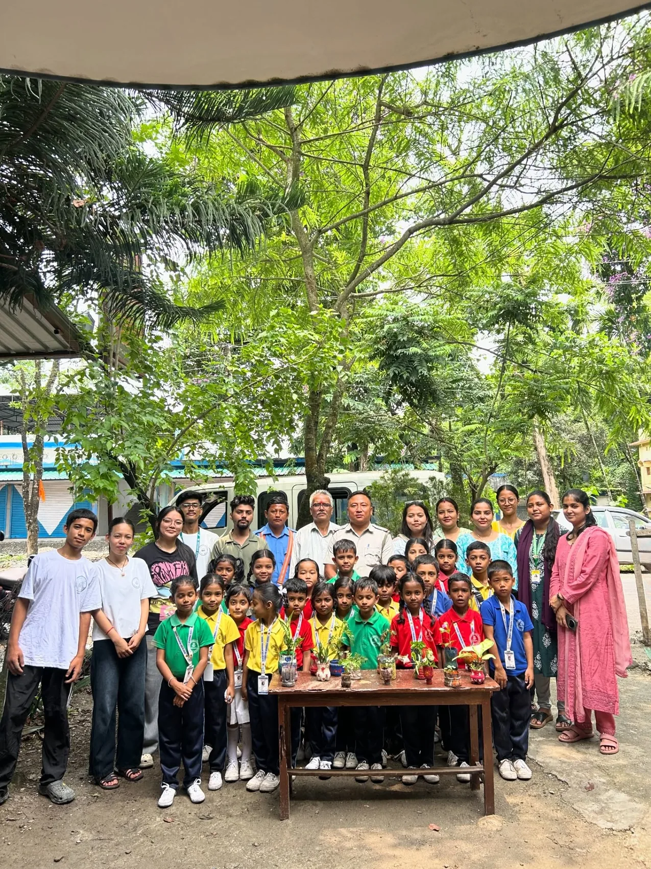 MGM students, educators and community members gathered around an outdoor activity table